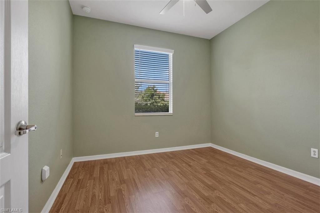 2391 Heydon Circle East Naples, FL 34120 - Photo 26 of 42 wooden floor in an empty room with a window