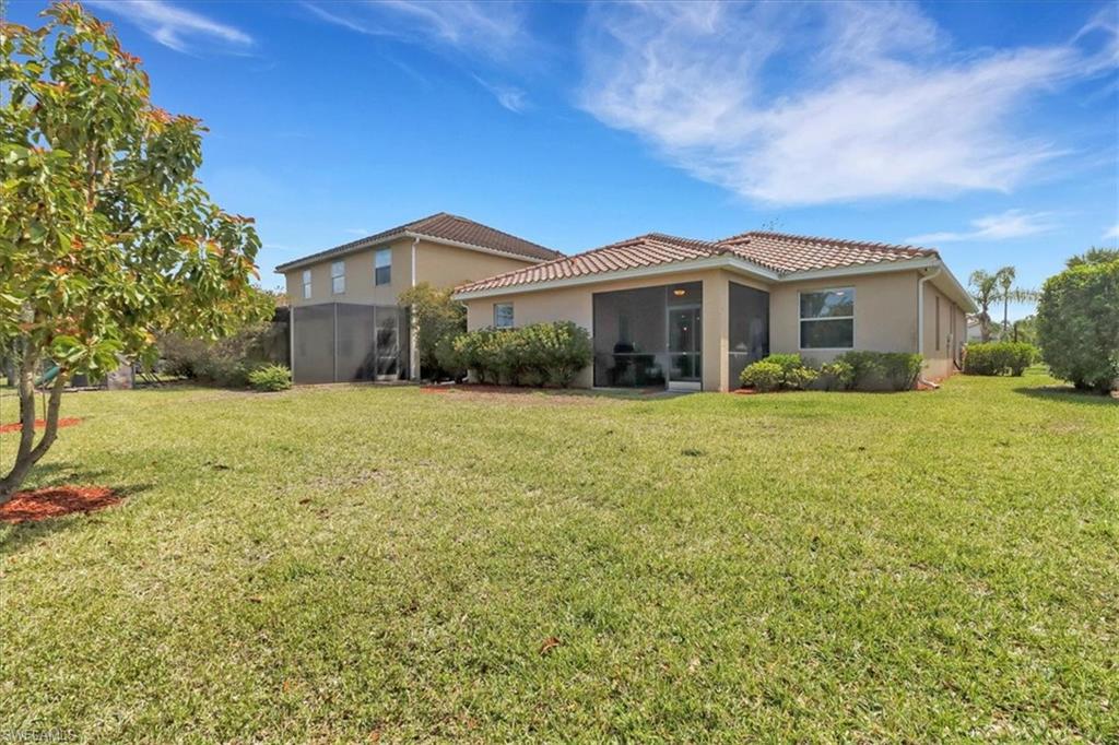 2391 Heydon Circle East Naples, FL 34120 - Photo 31 of 42 a front view of a house with a yard