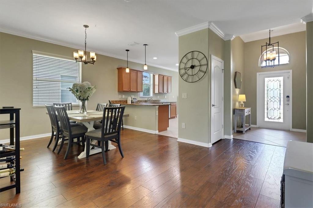 2391 Heydon Circle East Naples, FL 34120 - Photo 5 of 42 a view of a dining room with furniture wooden floor and a chandelier