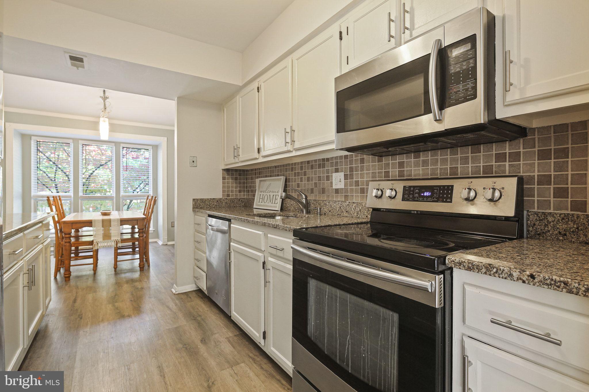 8205 Tall Trees Court Ellicott City, MD 21043 - Photo 7 of 37 Modern kitchen with sleek appliances.