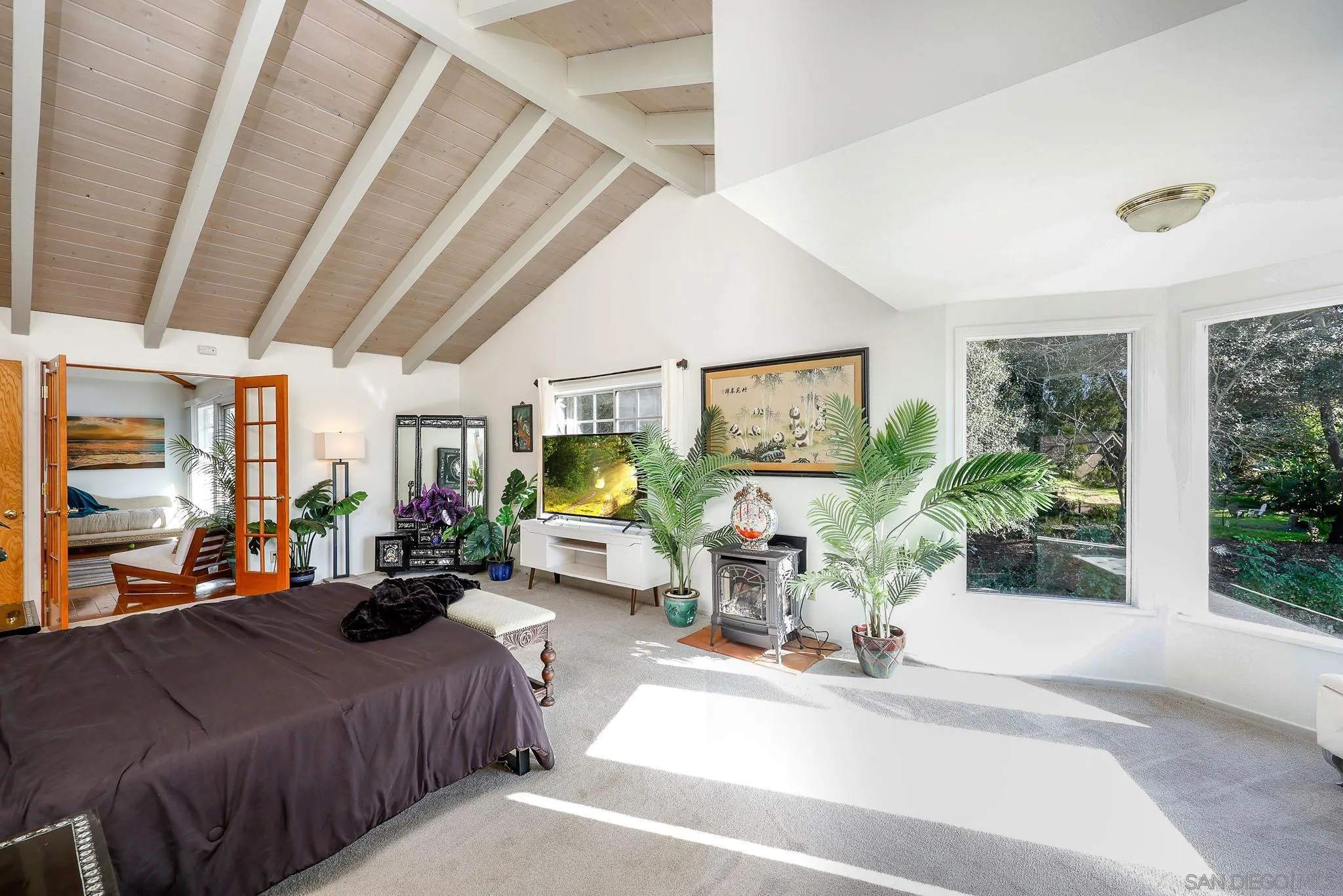 1553 Ranchwood Lane Fallbrook, CA 92028 - Photo 19 of 60 a bedroom with furniture a large window and a chandelier