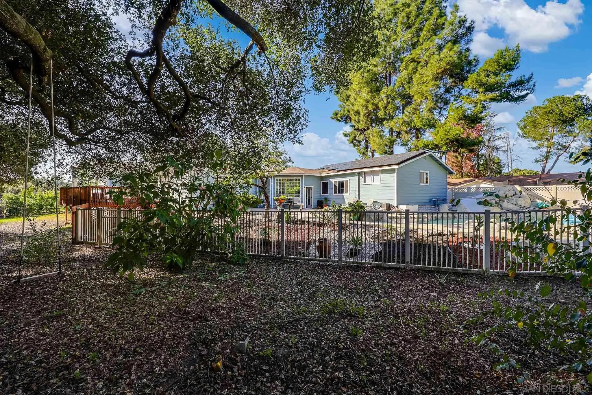 1553 Ranchwood Lane Fallbrook, CA 92028 - Photo 45 of 60 a backyard of a house with lots of green space