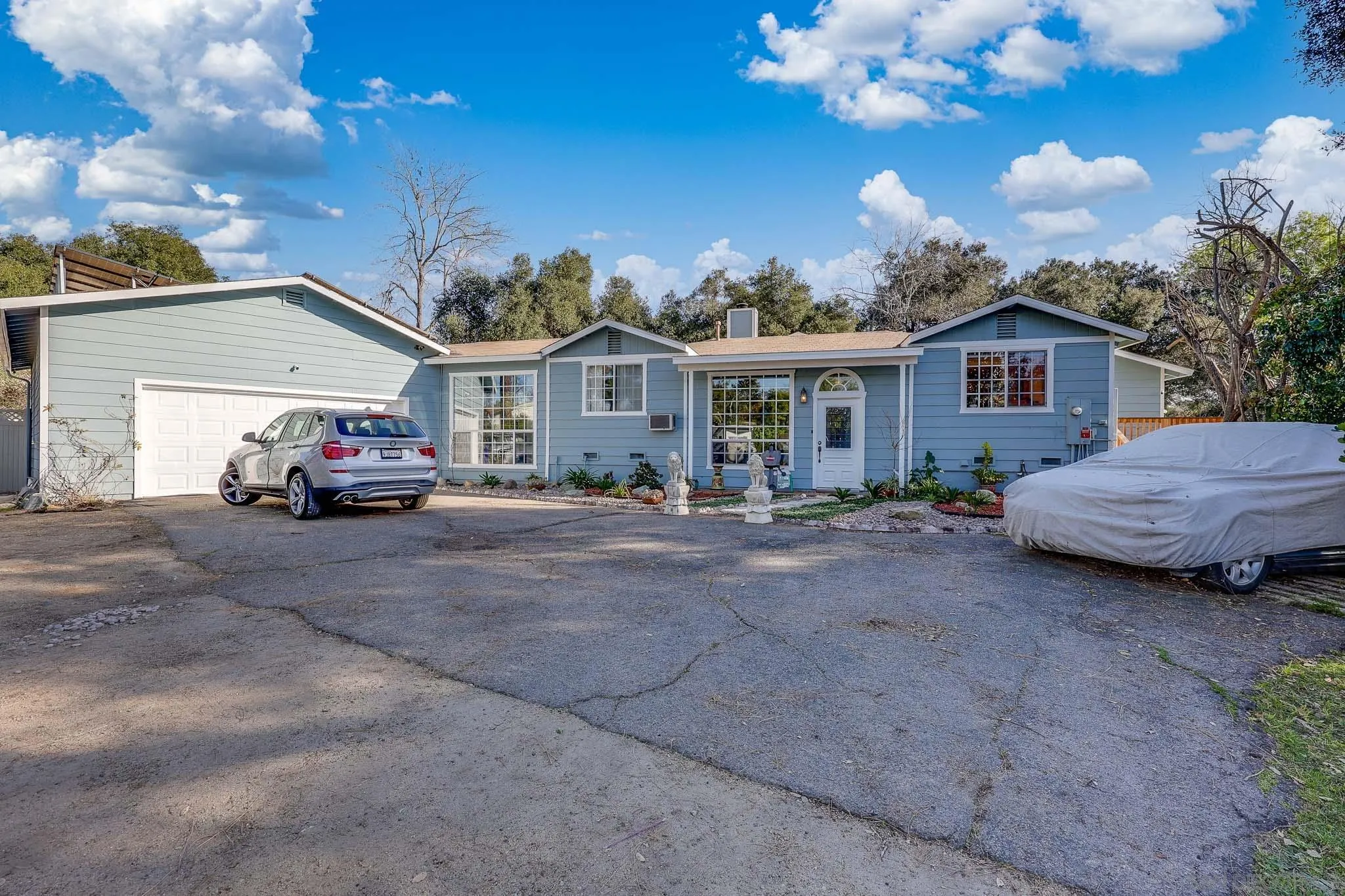 1553 Ranchwood Lane Fallbrook, CA 92028 - Photo 54 of 60 a car parked in front of house with a yard