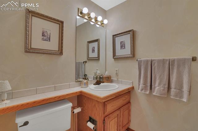 190 Desert Inn Way Colorado Springs, CO 80921 - Photo 13 of 31 Powder room opposite laundry with access from entry.