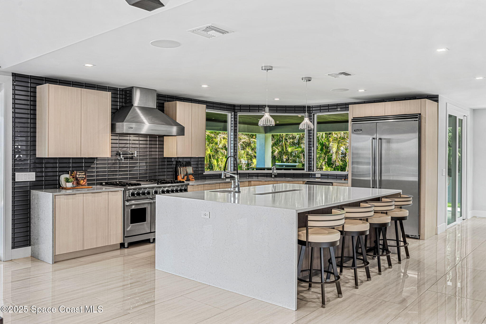 6225 Capstan Court Rockledge, FL 32955 - Photo 14 of 73 a kitchen with stainless steel appliances granite countertop a stove a refrigerator a kitchen island a table and chairs in it