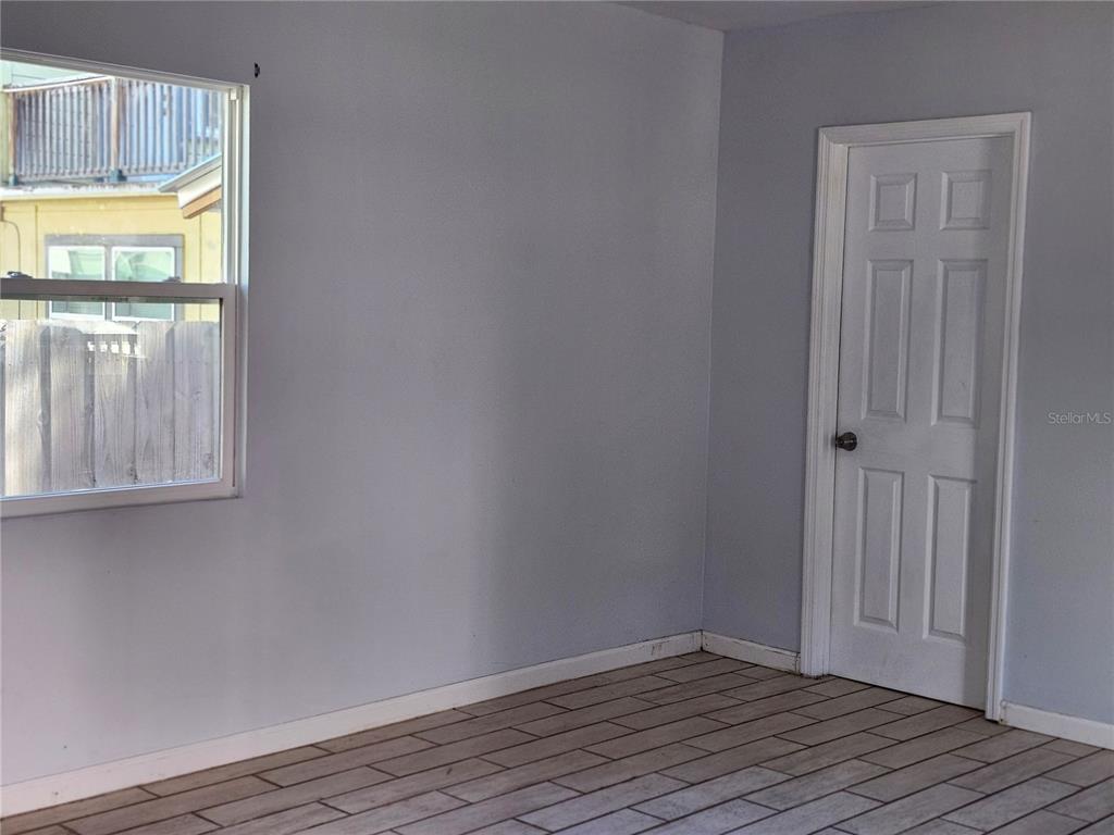 422 Northwest 9th Avenue Gainesville, FL 32601 - Photo 4 of 9 a view of an empty room with wooden floor and a window