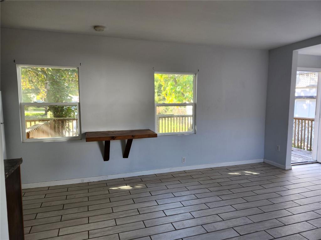 422 Northwest 9th Avenue Gainesville, FL 32601 - Photo 6 of 9 a view of an empty room with wooden floor and a window