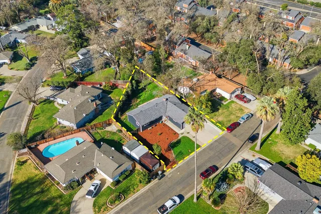 an aerial view of a house with a yard