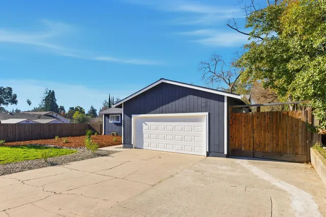 a front view of a house with a yard and a garage