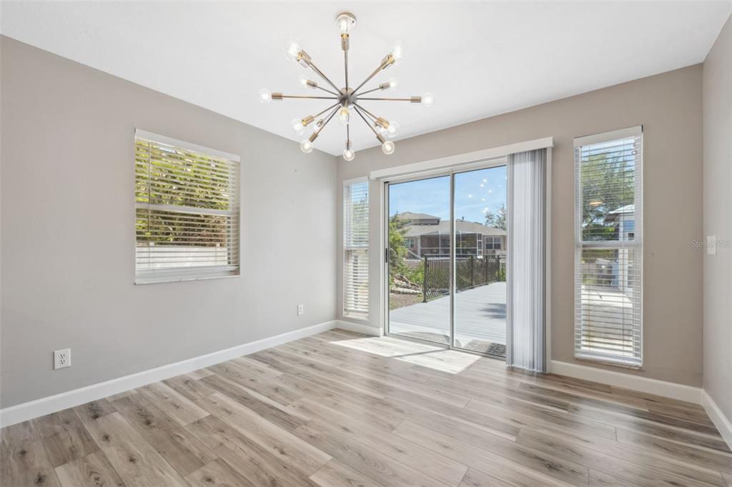 428 West Klosterman Road Palm Harbor, FL 34683 - Photo 11 of 44 a view of an empty room with wooden floor and a window
