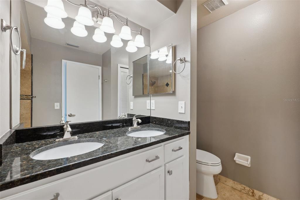 428 West Klosterman Road Palm Harbor, FL 34683 - Photo 16 of 44 a bathroom with a granite countertop sink mirror and toilet