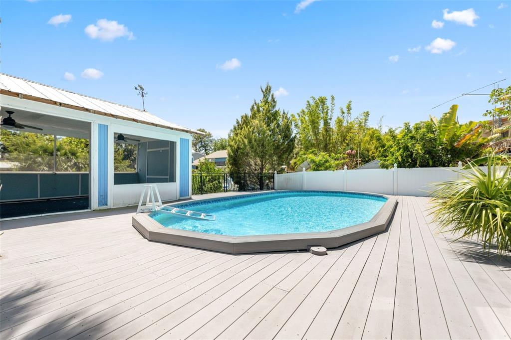 428 West Klosterman Road Palm Harbor, FL 34683 - Photo 29 of 44 a view of outdoor space with swimming pool and porch