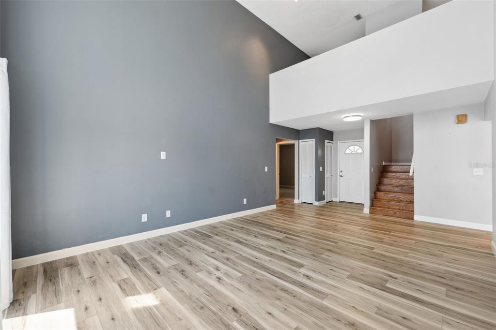 428 West Klosterman Road Palm Harbor, FL 34683 - Photo 5 of 44 a view of an empty room with wooden floor