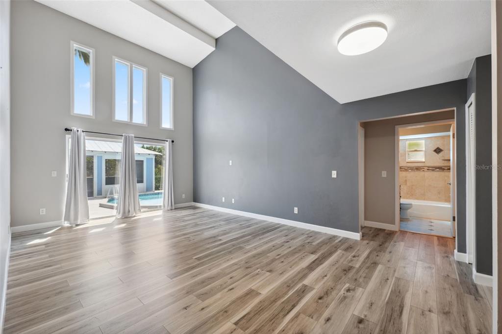428 West Klosterman Road Palm Harbor, FL 34683 - Photo 6 of 44 an empty room with wooden floor and windows