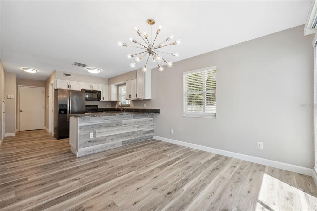 428 West Klosterman Road Palm Harbor, FL 34683 - Photo 8 of 44 a view of kitchen with cabinets appliances and wooden floor