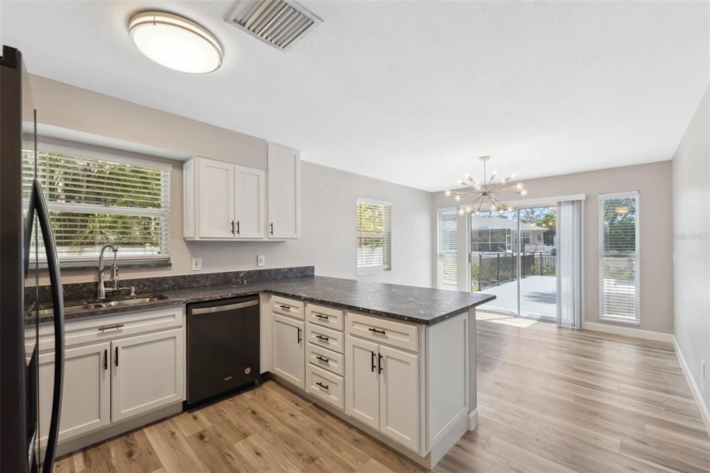 428 West Klosterman Road Palm Harbor, FL 34683 - Photo 9 of 44 a kitchen with stainless steel appliances granite countertop a sink and cabinets