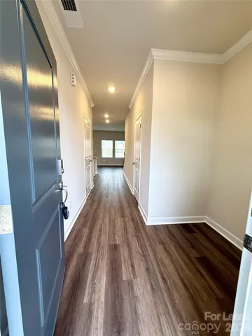 a view of hallway with wooden floor
