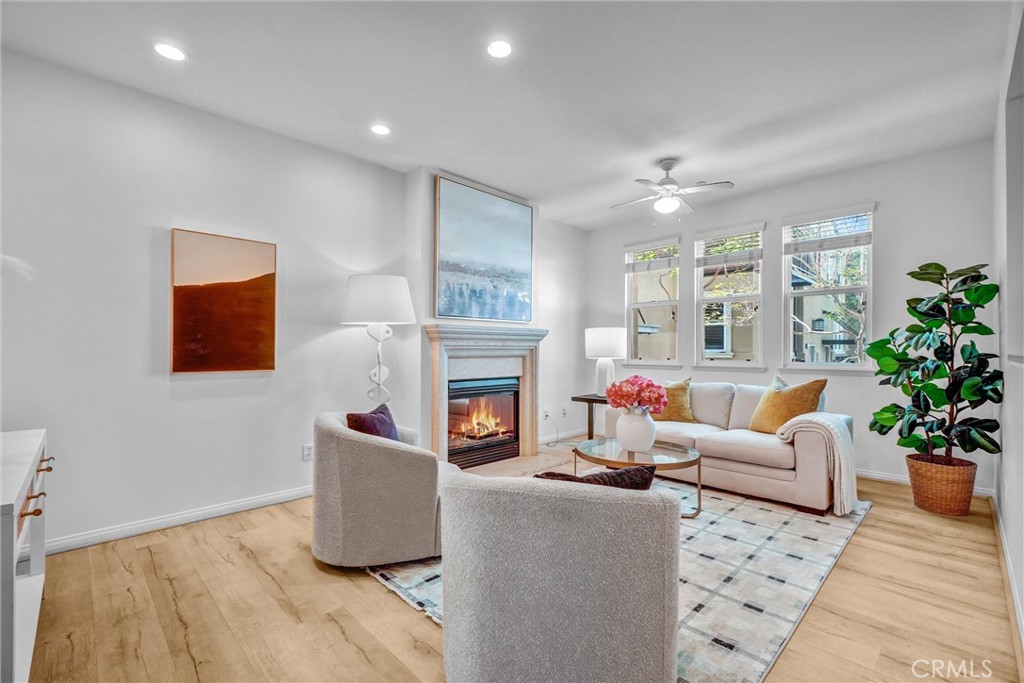 12 Shellprint Court Newport Beach, CA 92663 - Photo 12 of 42 Living Space with Fireplace, Laminate Flooring showing bright and airy.