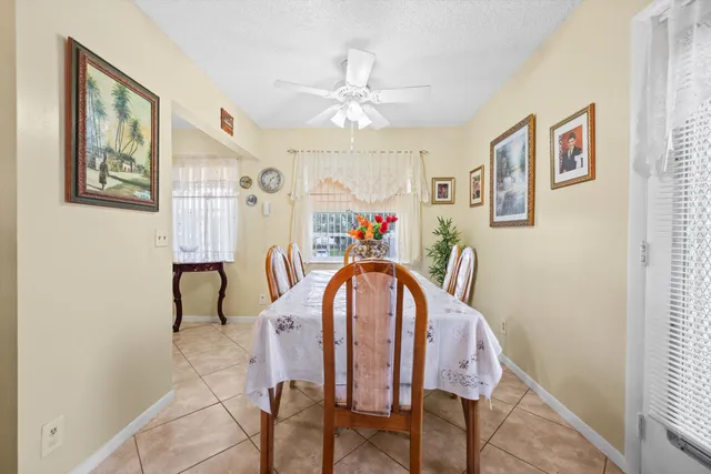 a view of a dining room with furniture and a chandelier