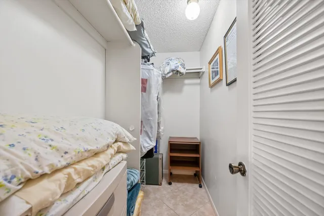 a bedroom with a bed and a ceiling fan