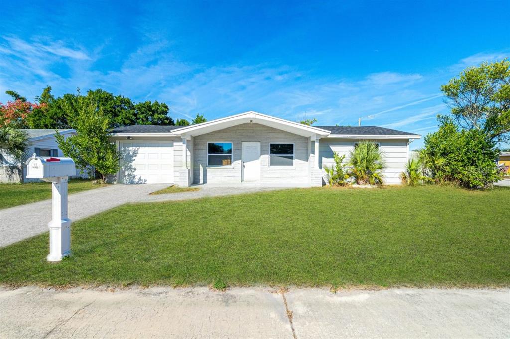 3309 Huntington Road Holiday, FL 34691 - Photo 1 of 1 a front view of a house with a yard