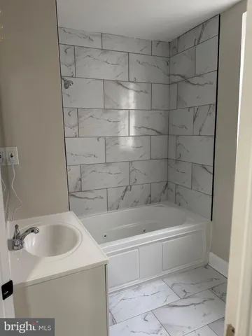 a bathroom with a toilet and a bathtub