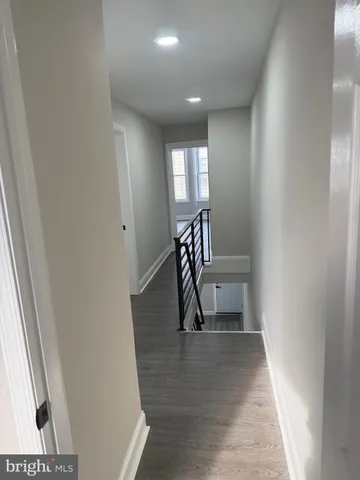 a view of staircase with white walls and a window