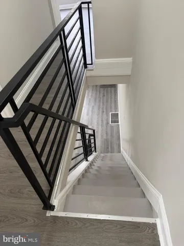 a view of staircase with white walls and a window