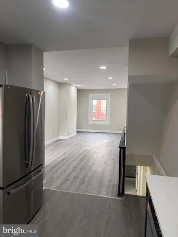 a view of a kitchen with a refrigerator washer and dryer