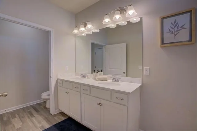 a bathroom with a double vanity sink and a mirror