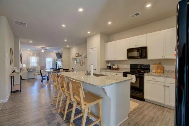 a large kitchen with a table and chairs