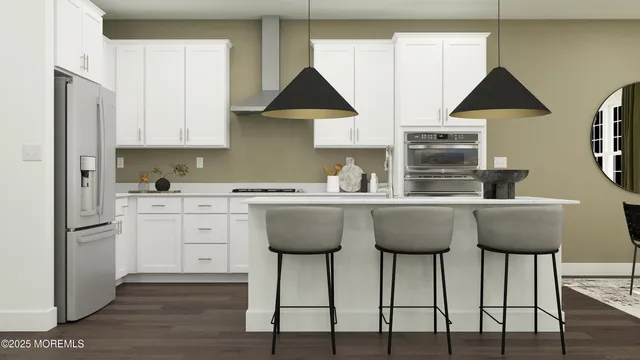 a kitchen with stainless steel appliances granite countertop a dining table chairs and white cabinets