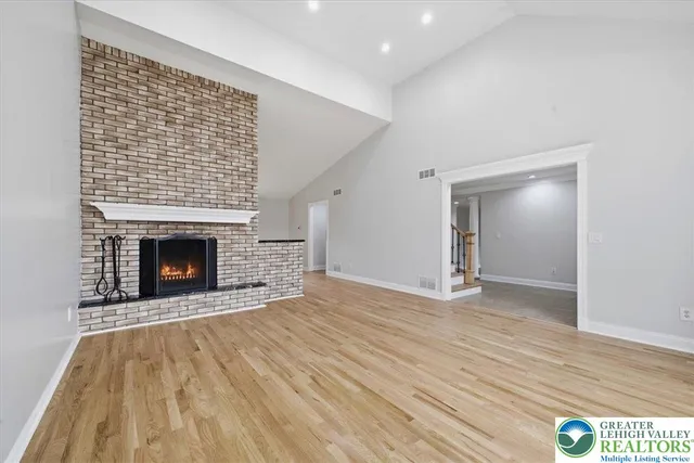 a view of a room with wooden floor and windows