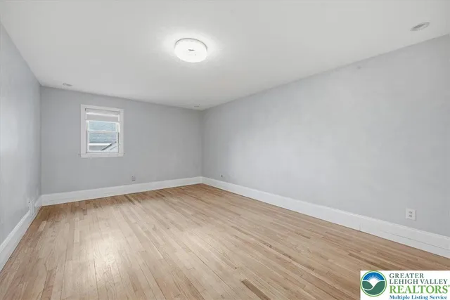 a view of a room with window and hardwood floor