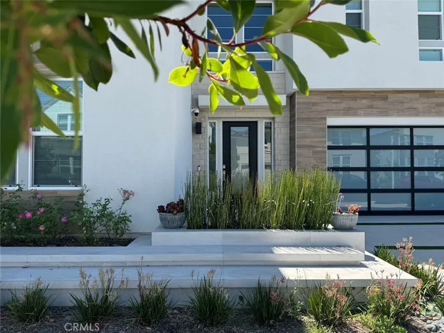 a view of a house with a yard and plants