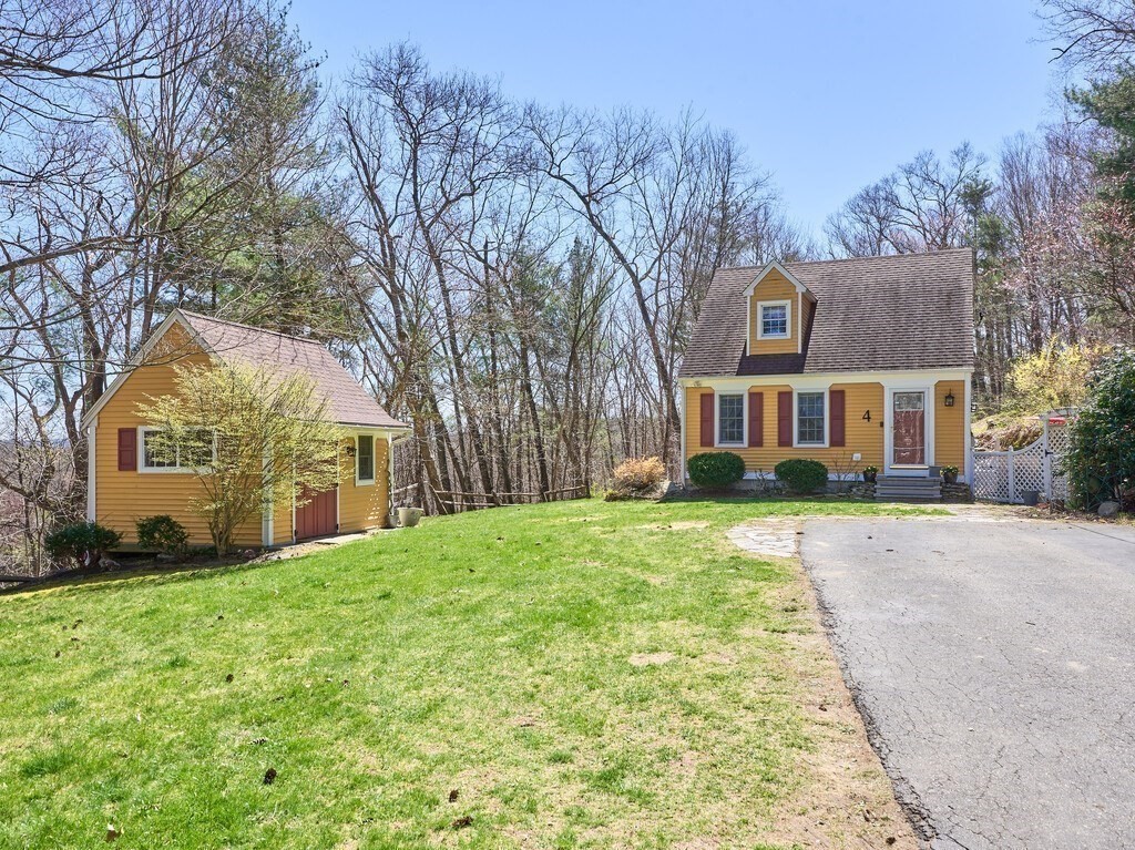 4 Martin Road Brookfield, MA 01506 - Photo 2 of 39 a front view of a house with a yard and garage