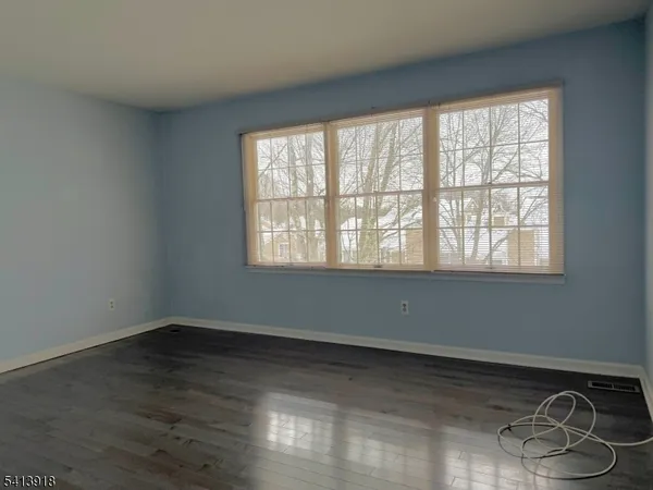 a room with a window and wooden floor
