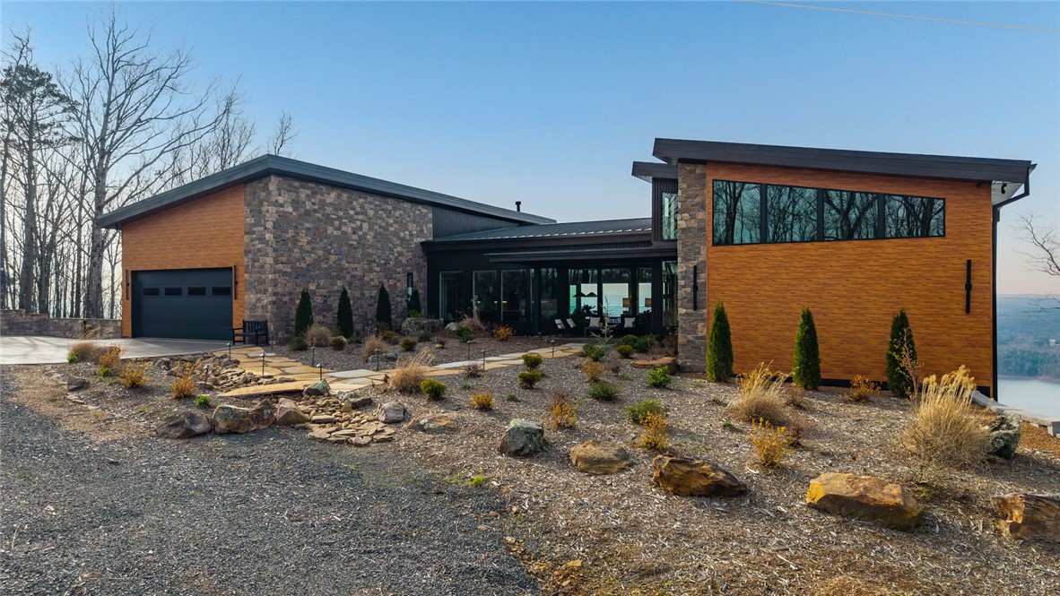 2623 Alum Cave Road Bee Branch, AR 72013 - Photo 2 of 60 Contemporary exterior featuring stone accents, wood-finish siding, and a low-slope roofline