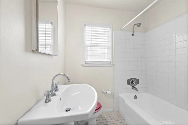 a white bath tub sitting next to a white sink