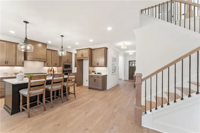a large kitchen with a table and chairs