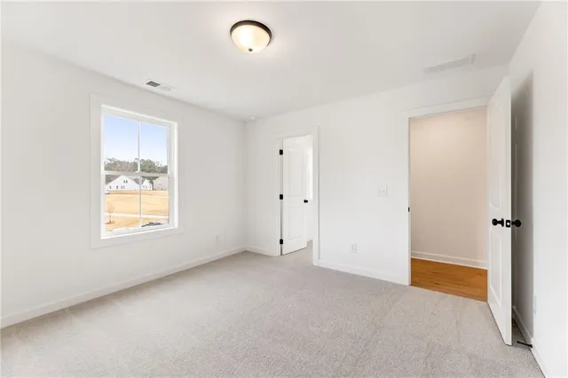a view of empty room with wooden walls