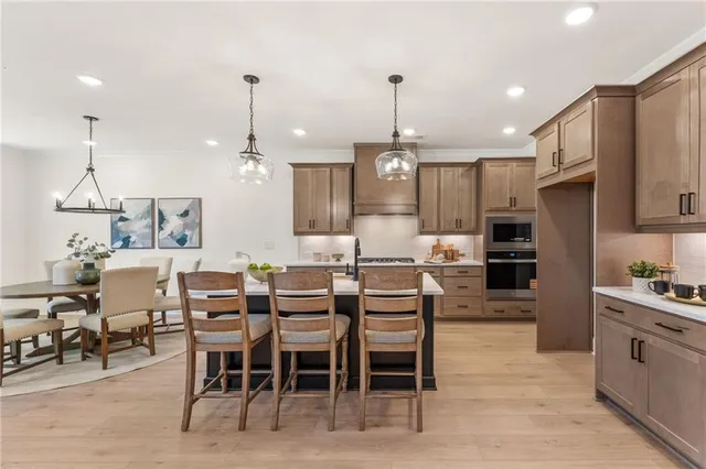 a large kitchen with a table and chairs