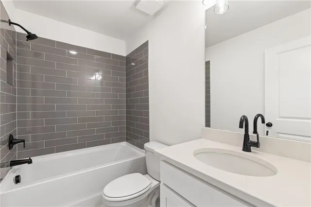 a living room with furniture kitchen view and a wooden floor