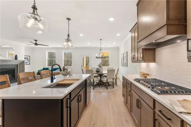 a kitchen with sink stove and cabinets