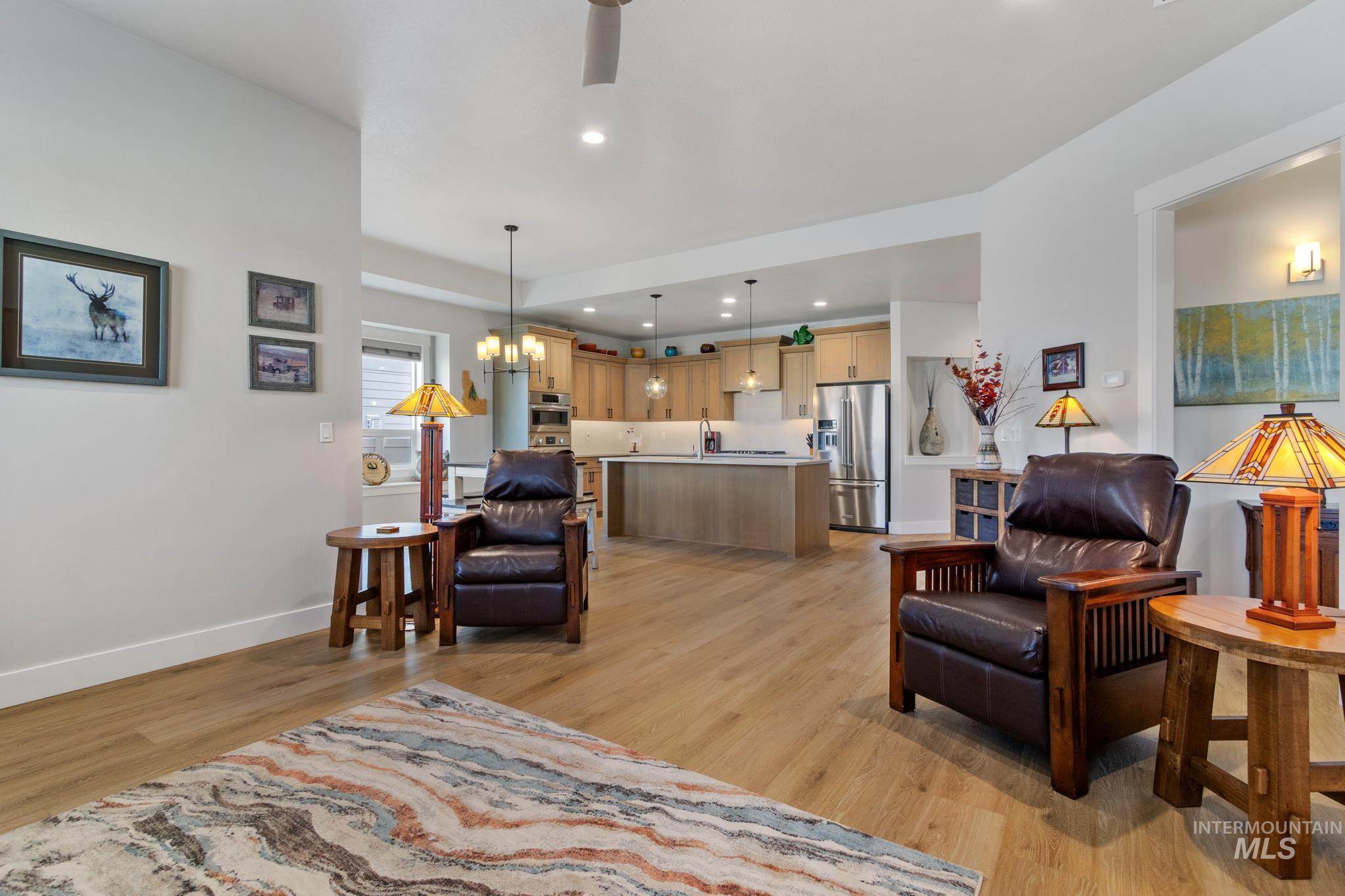 9864 West Aviara Street Star, ID 83669 - Photo 22 of 40 Living area featuring light wood-style flooring, hanging lights, and ceiling fan