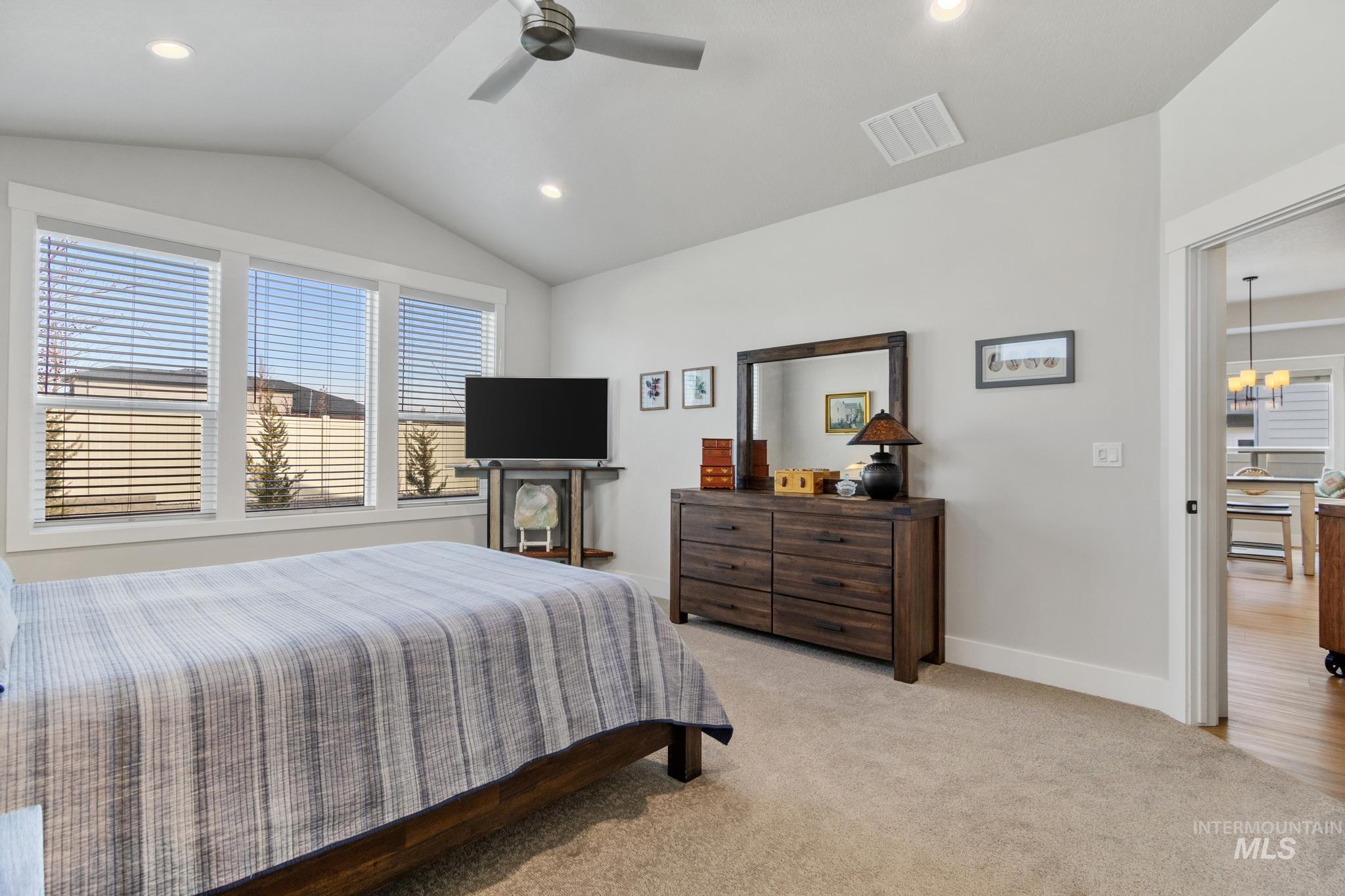 9864 West Aviara Street Star, ID 83669 - Photo 25 of 40 Bedroom featuring light carpet, ceiling fan, and a chandelier
