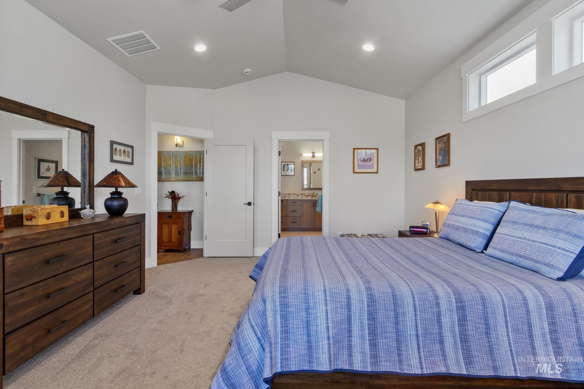 9864 West Aviara Street Star, ID 83669 - Photo 27 of 40 Bedroom with light carpet, ceiling fan, and ensuite bathroom