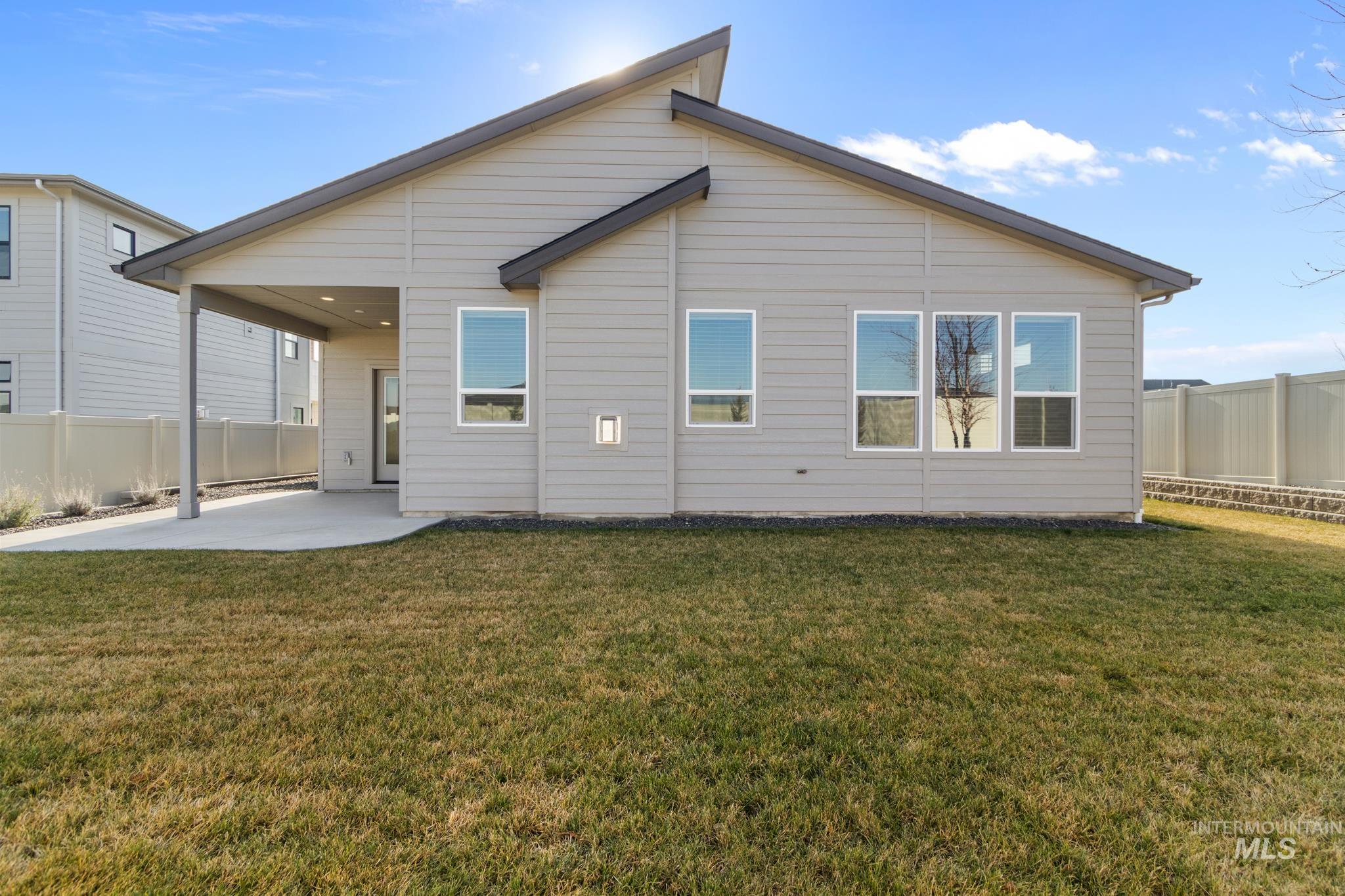 9864 West Aviara Street Star, ID 83669 - Photo 32 of 40 Rear view of house with a patio and a fenced backyard