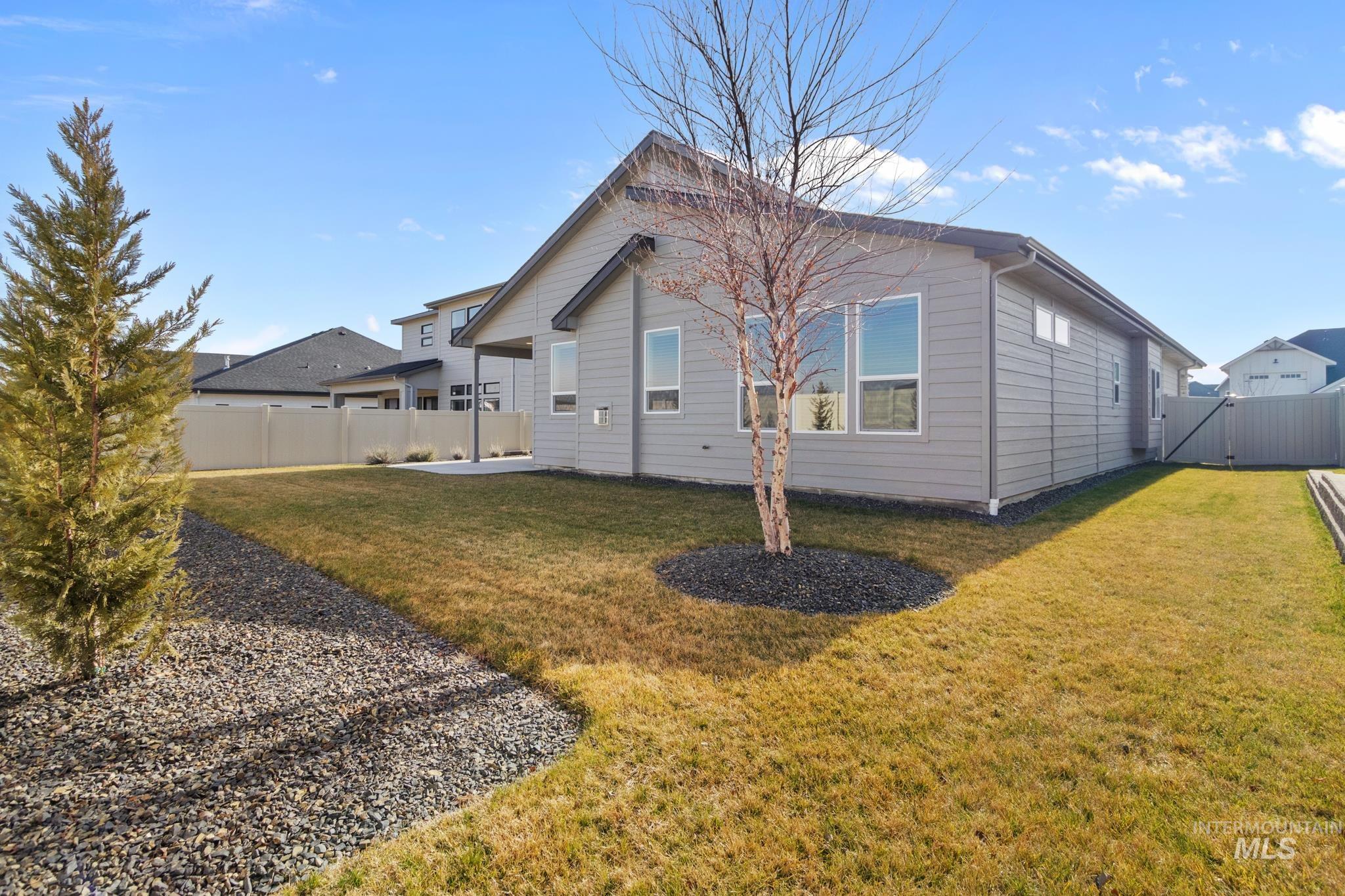 9864 West Aviara Street Star, ID 83669 - Photo 36 of 40 Back of property featuring a fenced backyard and a gate