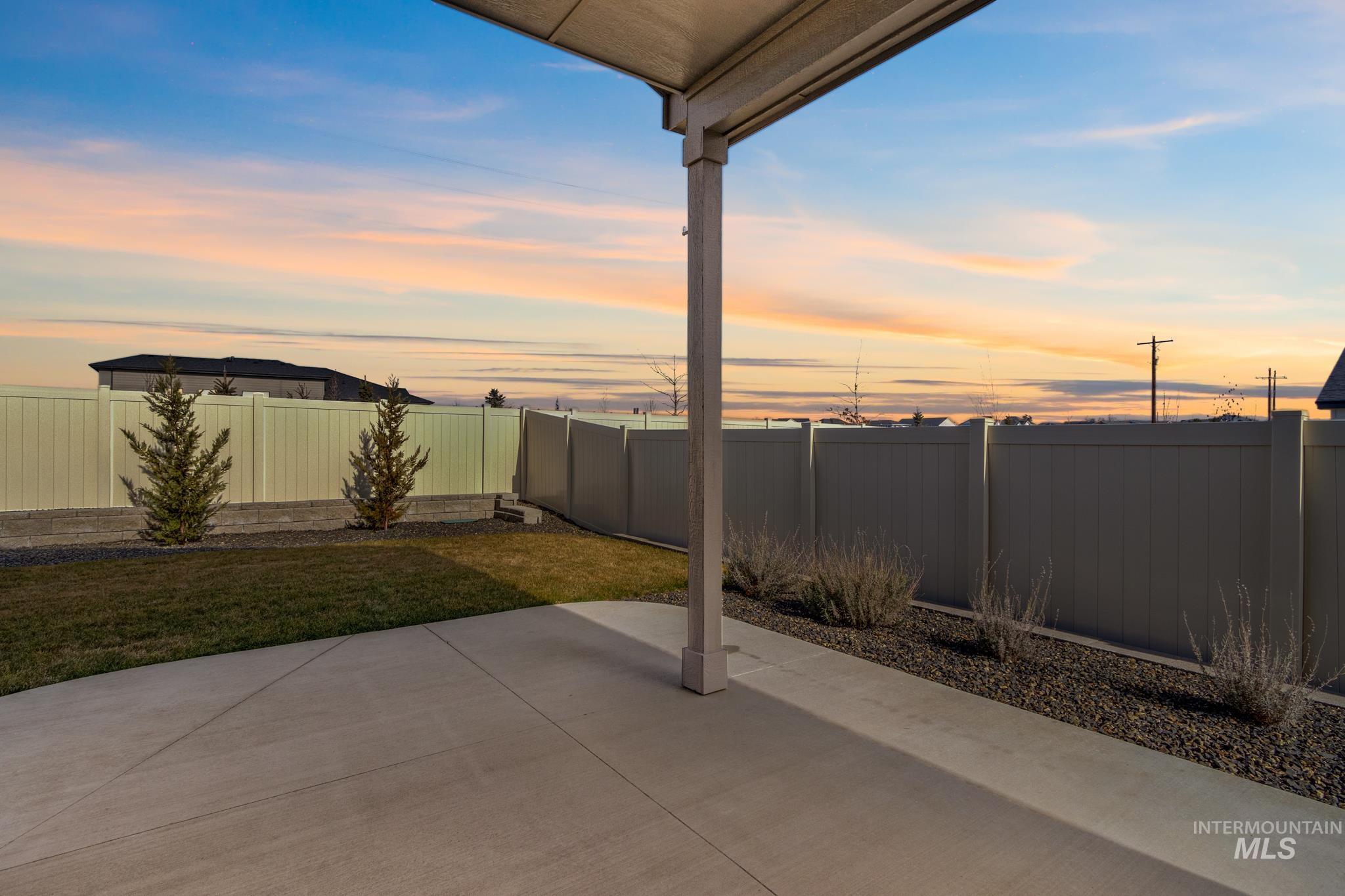 9864 West Aviara Street Star, ID 83669 - Photo 38 of 40 Patio terrace at dusk with a patio area and a fenced backyard